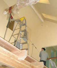 Spencer West operating the come-along to lift the stairway into place